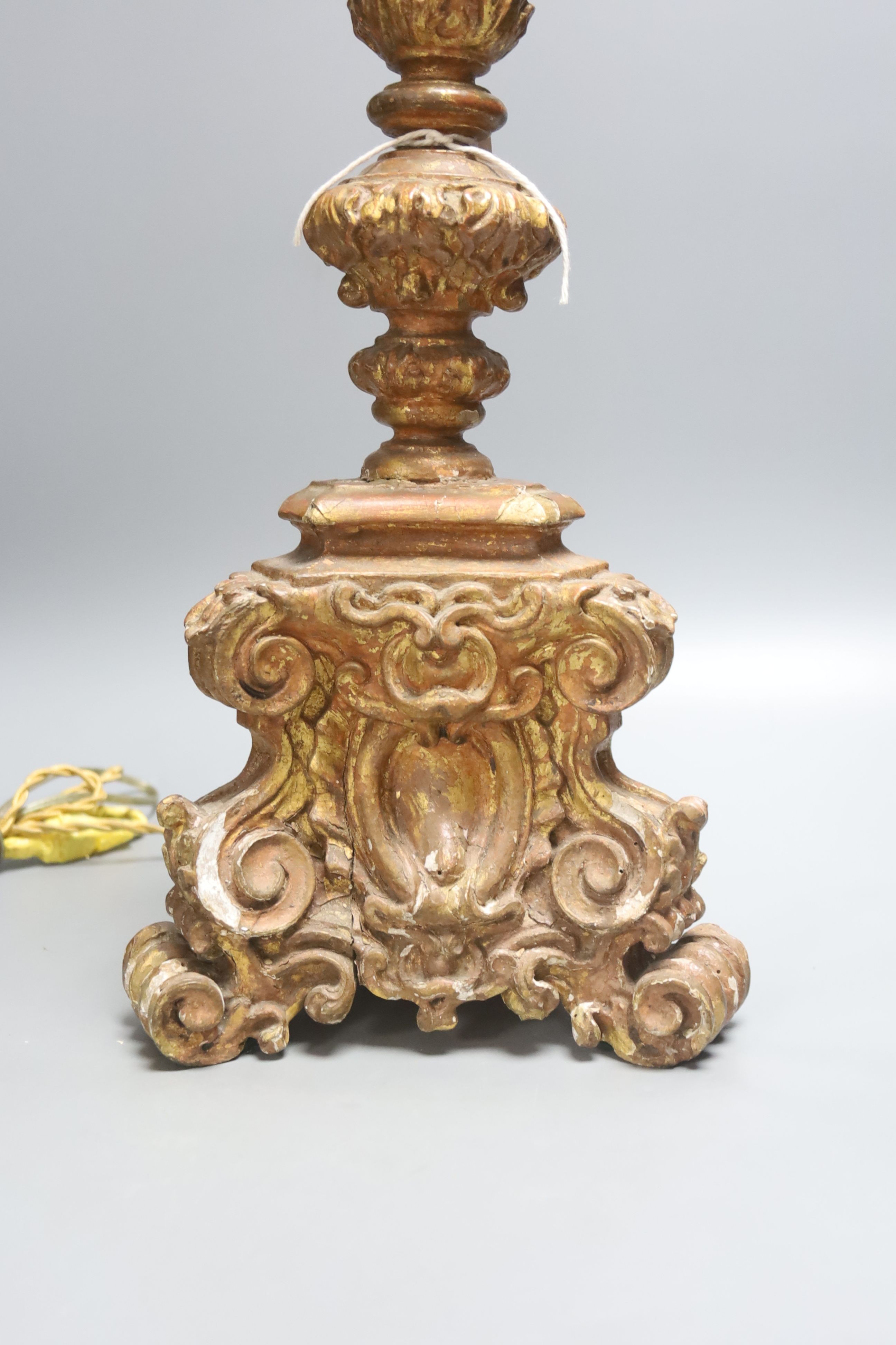 A late 19th century Italian Baroque style giltwood and gesso candlestand